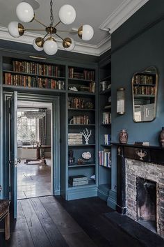 an image of a living room with bookshelves and fireplace