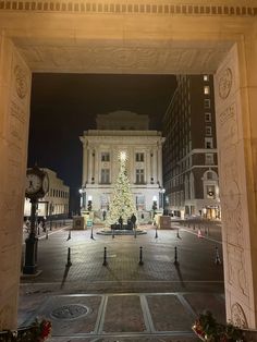 a large white christmas tree in the middle of a square