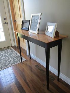 a table with two frames on it in front of a door