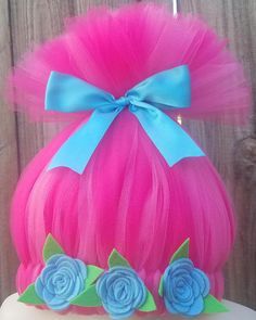 a pink wig with blue flowers on top