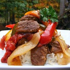 a white plate topped with meat and vegetables