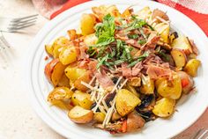 a white plate topped with potatoes and bacon