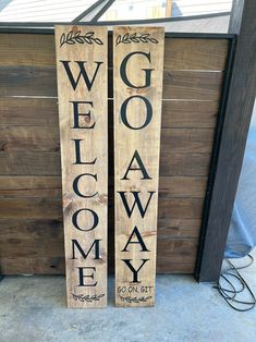 two wooden signs that say welcome and go on it