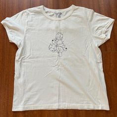 White Brandy Melville Devil Baby Cherub Graphic T-Shirt Brand No Flaws Cherub Brandy Melville, Brandy Melville Graphic Tees, Brandy Melville Shirts, White Wrap Top, Brandy Melville T Shirts, Dream Wishlist, Wishlist 2024, Preppy Clothes, Shark Shirt