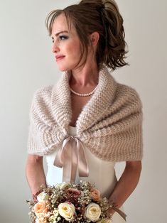 a woman wearing a shawl and holding a bouquet