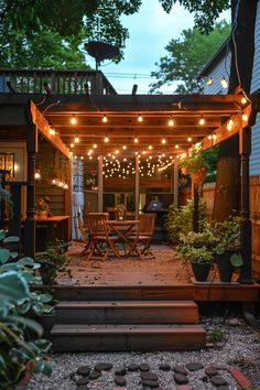 an outdoor patio with lights strung over it and wooden steps leading up to the deck