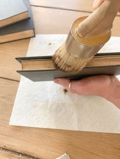 a person using a brush to paint a book