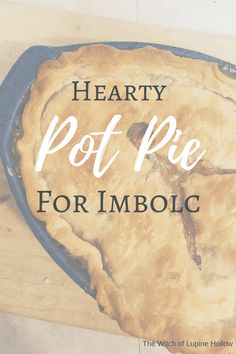 a hearty pot pie for imbolc on a cutting board with the words, hearty pot pie for imbolc