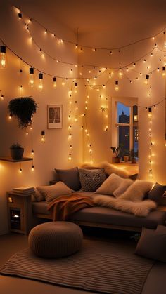 a living room filled with lots of lights next to a couch and ottoman covered in pillows