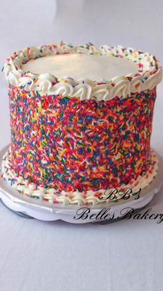 a cake with sprinkles on it sitting on a plate