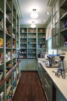 a kitchen filled with lots of green cupboards and counter top space next to a coffee maker