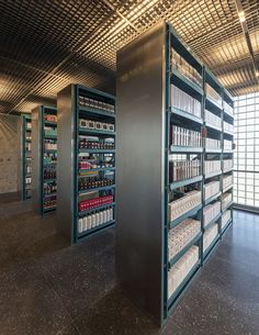 an empty library with shelves full of books and binders on the wall next to each other