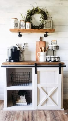 a kitchen island with baskets on it and shelves above the sink, in front of a white wall