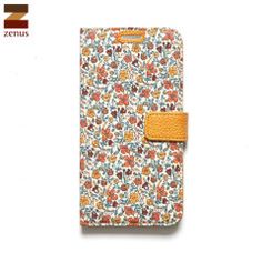 an image of a cell phone case with flowers on the front and yellow leather strap