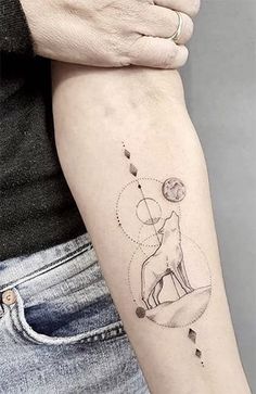 a woman's arm with a tattoo on it that has an image of a dog and stars