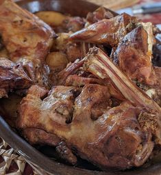 meat and potatoes in a bowl on a table