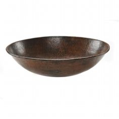 a brown bowl sitting on top of a white table