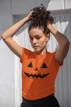 A spooky and fun Pumpkin face design on this T-Shirt is perfect for Halloween enthusiasts and anyone who loves festive attire. This comfortable and durable tee can be worn year-round for casual or semi-formal occasions. Product features - Shoulder tape for stability - Tubular knit for seamless construction - Ribbed knit collar for elasticity - Made from strong and smooth fabric - Classic fit and tear-away label for comfort Care instructions - Machine wash: warm (max 40C or 105F) - Non-chlorine: bleach as needed - Tumble dry: medium - Do not iron - Do not dryclean Spooky Short Sleeve Tops For Costume Party, Spooky Orange Crew Neck Top, Spooky Halloween Tops, Spooky Short Sleeve T-shirt For Costume Party, Halloween Novelty Short Sleeve Tops, Spooky Orange Crew Neck T-shirt, Orange Crew Neck Top For Halloween, Orange Cotton Tops For Halloween, Halloween Orange Crew Neck T-shirt