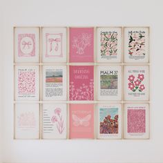 a white wall with many pink and white cards hanging on it's side,