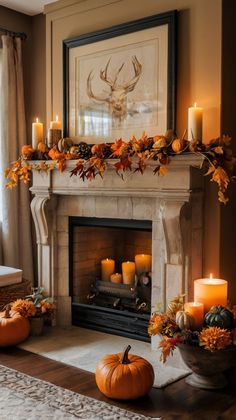 a mantel with candles and pumpkins on it