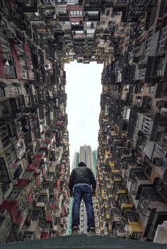 a man standing in the middle of a tall building