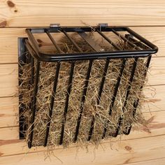 a basket with hay in it hanging on the wall