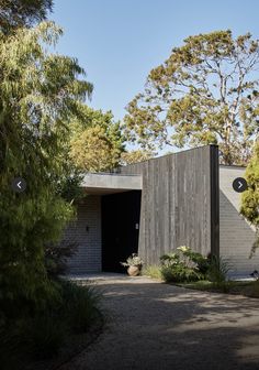 an entrance to a house surrounded by trees