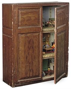 an old wooden cabinet with many items in it's doors and shelves on both sides