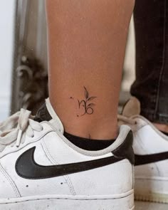 a woman's foot with a small tattoo on her left ankle and the number 35