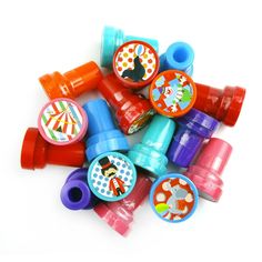 a pile of colorful plastic toys on a white surface