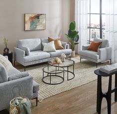 a living room with couches, chairs and coffee table in front of a large window