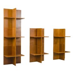 three wooden bookshelves are shown against a white background