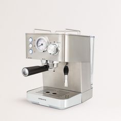 an espresso machine sitting on top of a white table