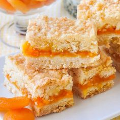 several pieces of cake sitting on top of a white plate next to some oranges