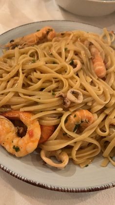 a plate of pasta with shrimp and mushrooms