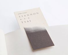 an open book with a black and white color on the cover, sitting on a table