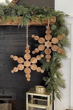 a fireplace decorated for christmas with ornaments hanging from it's mantle and pine branches