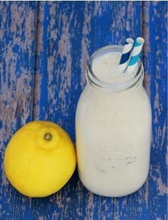 a lemon next to a glass of milk