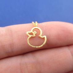 For the gal who can't wait for bath time, this necklace features a pendant made in the shape of a rubber ducky! Available in gold or rose gold, so cute! Size: The duck charm measures 1.1 cm tall by 1 cm wide and hangs on a 16 inch (41 cm) long chain that closes with a lobster clasp! Material: Gold/ Rose Gold Plated BrassStore FAQ | Shipping Info | Returns & Exchanges Duck Items, Duck Outline, Duck Necklace, Ducky Duck, Rubber Duckies, Rubber Ducky, Solitaire Necklaces, Jewelry Lookbook, Girly Jewelry