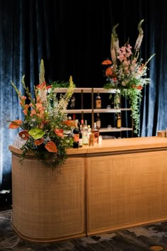 the bar is decorated with flowers and bottles