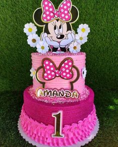 a minnie mouse birthday cake with flowers on top