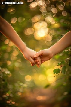 two people holding hands in the middle of a forest with sunlight shining down on them