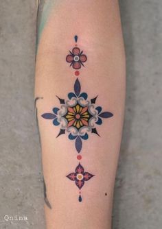 a woman's leg with an artistic tattoo design on her left calf and thigh