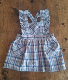 FRENCH VINTAGE 50's, lovely little pinafore dress / apron dress, blue / beige / red checkered cotton fabric, two small patch pockets, striped ribbon detailing, buttoned at the waist ( plastic button ), belt to tie. Length 19,4" Estimated size 3 years Length 20,8" Estimated size 4 years New old stock ( washed once ) In case of multiple purchases, if you want an accurate shipping estimation, please contact me ; I do always refund overcharged shipping from 1 Euro overpaid ! Thank you for your visit Vintage Cotton Plaid Dress, Vintage Sleeveless Plaid Cotton Dress, Vintage Sleeveless Plaid Dress, Cotton Plaid Ruffled Dress For Picnic, Vintage Cotton Gingham Plaid Dress, Cotton Plaid Dress With Ruffles For Picnic, Vintage Gingham Plaid Cotton Dress, Retro Gingham Plaid Cotton Dress, Plaid Cotton Cottagecore Dress