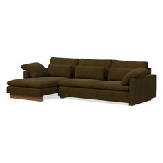 a brown sectional couch with pillows on it's back and the seat folded out