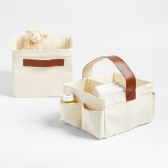 two canvas storage bags with leather handles, one in white and the other in brown