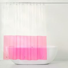 a pink and white shower curtain is hanging in front of a bathtub with a sink