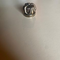 a silver ring sitting on top of a white table