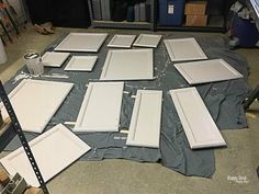 several pieces of white paint sitting on top of a gray tarp in a room