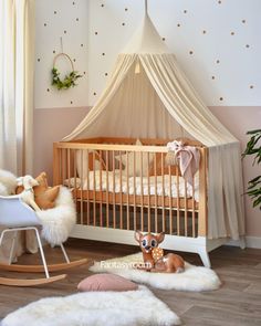 a baby's room with pink and white decor